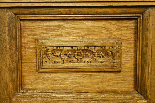 Close-up of traditional ornamental wood carving on an antique oak panel inside the historic Martinikerk church in Doesburg, cultural heritage craftsmanship in the Netherlands