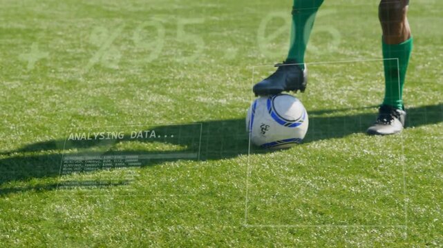Green-kit player controlling ball, retaining possession while opponent closing sports HUD analysing
