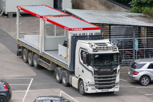 Nancy, France - May 19th 2026 : View on a white truck Scania S580 for the delivery of containers on a construction site.