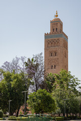 Obraz premium Famous Koutoubia Mosque minaret tower rising into a blue sky in Marrakech, Morocco