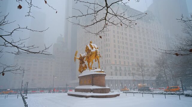 Snow covers the William Tecumseh Sherman Monument and the square around it. Heavy snowstorm in New York City, USA.