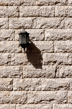 Decorative vintage street lantern on the concrete wall in Abu Dhabi, UAE