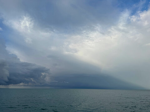 Cloudy sky over ocean water.