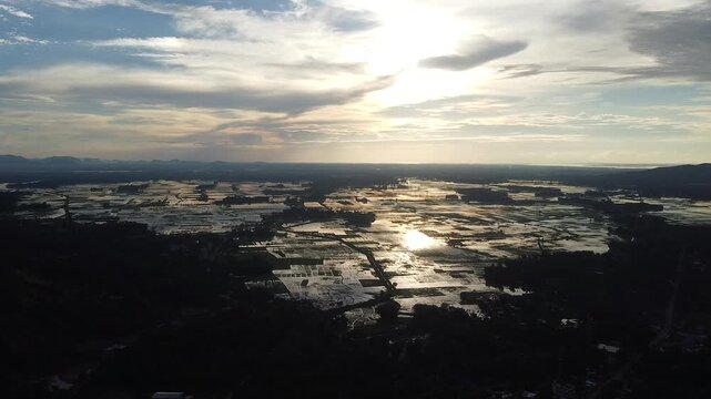 .Aerial drone view at evening over a peaceful Assamese village in India, showcasing nature, greenery, houses, and rural life. 4K HD