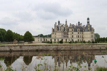 Obraz premium Symmetrical castle reflection in calm moat