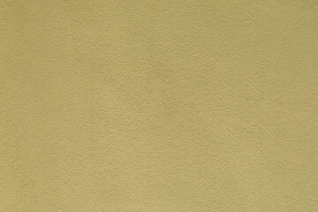 Close-up of a textured pale yellow-green stucco wall, minimalist background, architectural detail, rough surface design. © magic_cinema