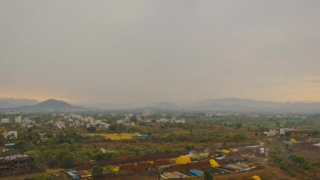 Wide angle view of Pune, timelapse of a windy rainy  sunset over the hills.