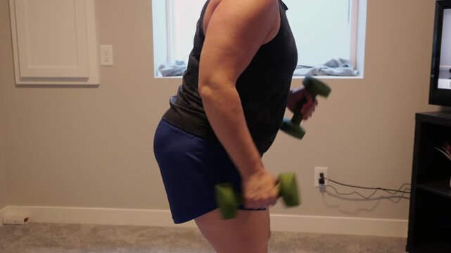 Woman Doing Video Workout in Home Gym - Home Fitness Exercise Weightlifting Healthy Lifestyle Building Muscle Daily to Age Gracefully