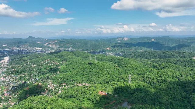 An aerial panoramic view from Gar Bahanga Forest Reserve showcases Fovert and Guwahati City, Guwahati city, Assam ,india  revealing a captivating ecosystem where the human population is integrated int