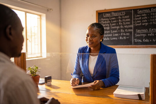 Female Financial Advisor Consulting Client at Local Banking Office