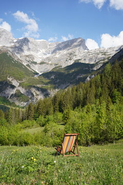 Lonely colorful reading chair in an alpine meadow in the Alps