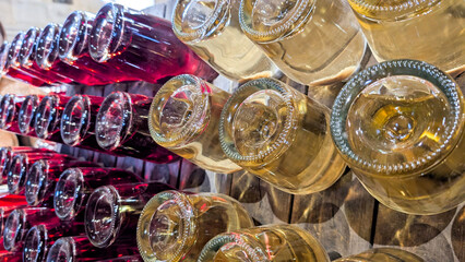 Fototapeta premium Wine cellar storing numerous bottles of red and white wine, capturing the essence of winemaking and the careful aging process in a rustic winery environment
