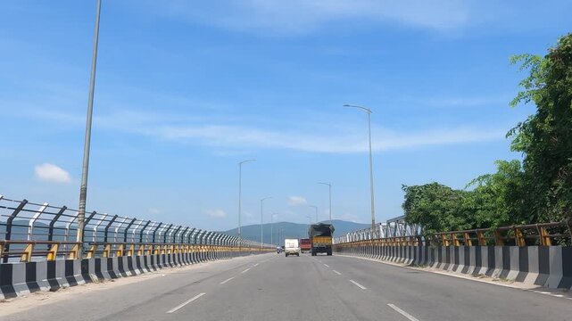 This is a moving steady shot of the Brahmaputra bridge in Guwahati, Assam, capturing two adjacent bridges and the surrounding natural beauty on both sides.4k