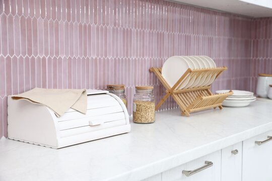 Breadbox and dishware on counter in kitchen