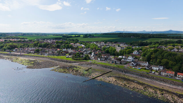 High angle aerial view of the coastal village of East Wemyss in Fife, Scotland, featuring the rocky shore along the Firth of Forth.
