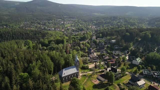 Szklarska Poręba - Polska - kości&oacute;ł i panorama miasta oraz Karkonoszy nagrana dronem z wysokości. G&oacute;ry, lasy, kości&oacute;ł, piękne widoki