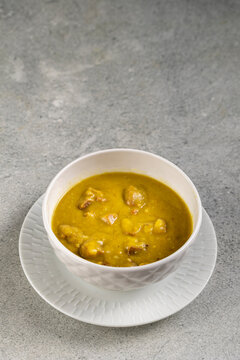 Homemade Split Pea Soup Served in White Bowl on Gray Table