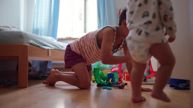 Brothers playing together with toys on bedroom floor sharing quiet sibling interaction concept of creativity bonding and everyday childhood life