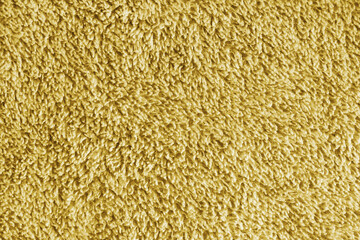 Close up, macro yellow microfiber bath towel texture, soft fluffy terry cloth surface, absorbent fabric details. Cozy textile material background for bathroom, cleaning or spa concepts © katyamaximenko