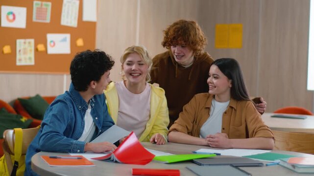 Happy students girls guys throw papers pass exam smiling finish education school friends university complete holiday weekend session diploma done graduate Caucasian boys female male together studying