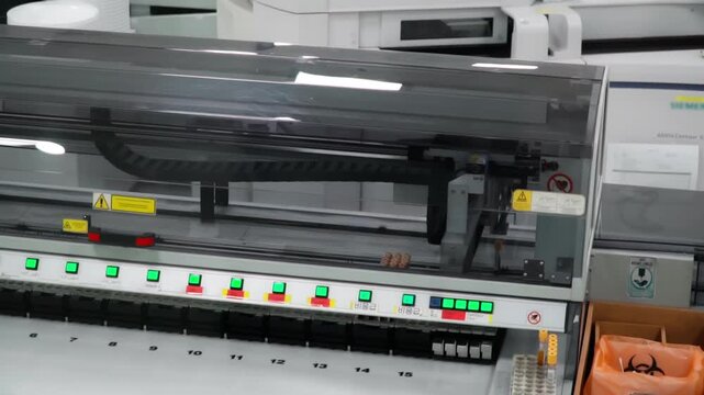 Automated robotic pipetting system precisely dispenses blue liquid into vials in a sterile lab.