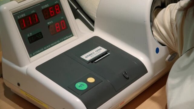 Automatic blood pressure monitor stand in the hospital table.