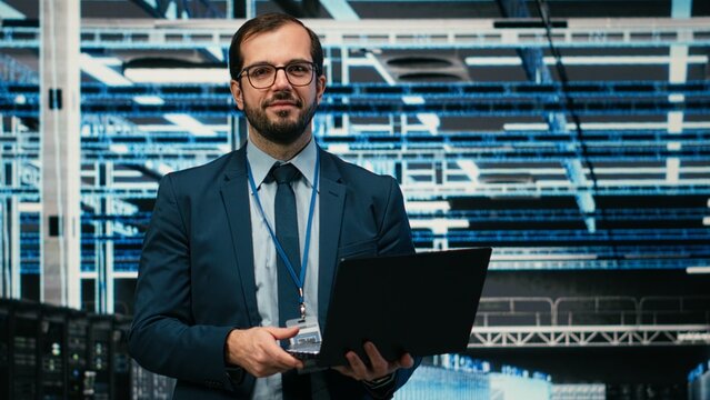 Happy data center programmer using laptop and AR tech to monitor error logs, debugging systems, Cheerful server hub employee running diagnostics checks on wireframe mesh infrastructure, camera B.