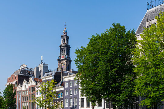 landmark church tower above commercial buildings in amsterdam netherlands