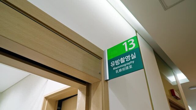 The board in the wall with text "Mammography" in the English, Korean and Chinese languages. Medical and care.