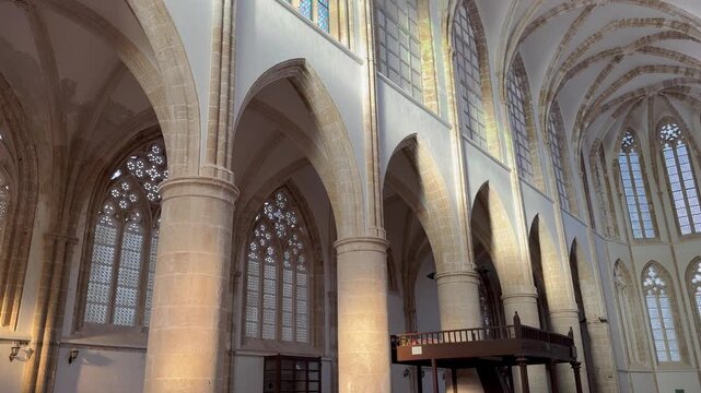 Slow camera through Lala Mustafa Pasha Mosque, Famagusta, Cyprus. Former Gothic Cathedral of St. Nicholas with stone arches, vaulted ceilings, tall windows. Medieval Lusignan architecture.