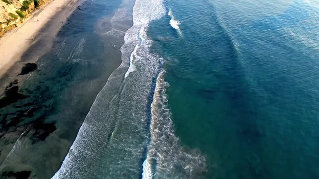 Aerial View of Coastal Bluffs and Incoming Surf