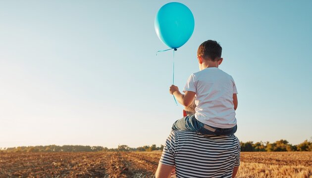 Father and Son Enjoying a Sunny Day with a Blue Balloon.