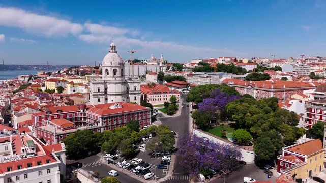 Aerial establishing shot of Lisbon cityscape with blooming jacaranda trees, Campo de Santa Clara and National Panteon. lisbon, Portugal
