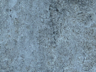 Obraz premium Textured gray concrete surface with cracks and imperfections, suitable for backgrounds, industrial designs, or grunge aesthetics.