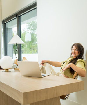 Relaxed Professional Woman Working Remotely in Bright Office Interior