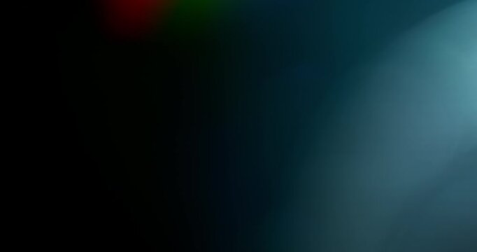 Slow motion of lens flare isolated on black background. Colored spectrum. Cinematic glowing light overlay with optical streaks and rays for VFX compositing and transitions.
