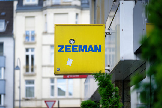 Cologne, Germany May 25 2025: A yellow outdoor sign of the Dutch textile discounter Zeeman with a small sticker, located in the urban district of Ehrenfeld