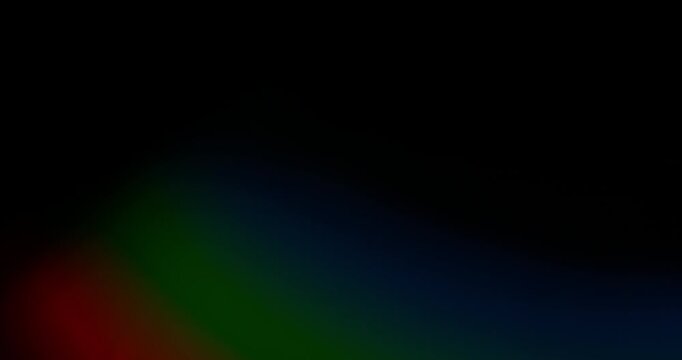 Slow motion of lens flare isolated on black background. Colored spectrum. Cinematic glowing light overlay with optical streaks and rays for VFX compositing and transitions.