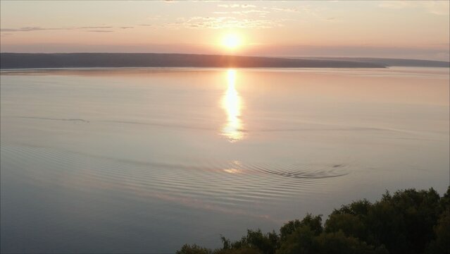 Beautiful, bright sunrise over the lake. Sunset over the drone reservoir frames