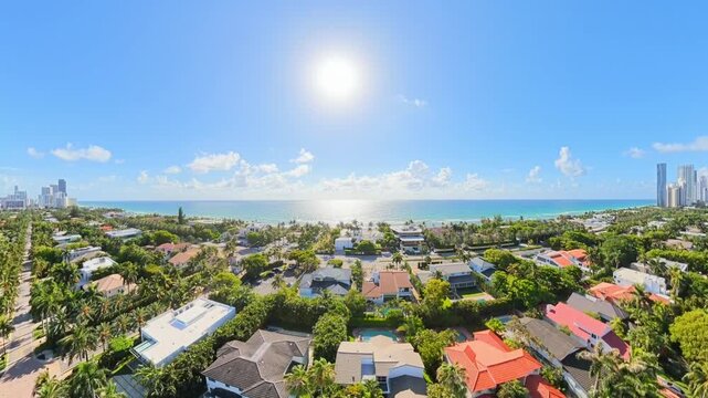 Aerial flight from mansion homes to coastal ocean Golden Beach Miami Florida 2026