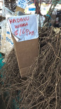 Raw Fijian kava yaqona lateral roots sourced from Kadavu Island at local market with price tag in capital city Suva, Fiji in South Pacific