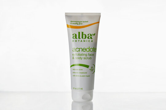 bottle of Alba Botanica acnedote exfoliating face and body scrub, with salicylic acid, on a white background