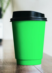 Obraz premium Vibrant green coffee cup design, suitable as mockup