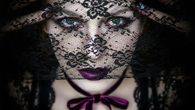 Mysterious young woman with dark makeup wearing a black lace veil and purple velvet choker