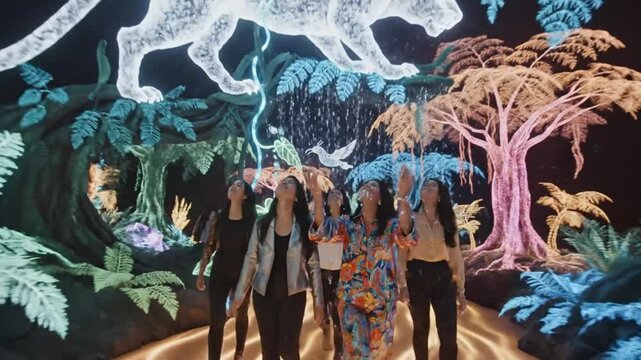 Women explore immersive digital art exhibit