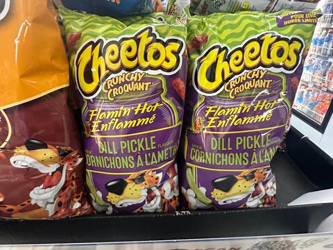 Cheetos Flamin Hot Dill Pickle flavoured snack bags displayed on retail shelf. May 26 2026. Gleichen Alberta Canada. For editorial use only.