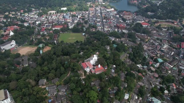 Aerial drone footage of the great Buddha Sri Maha Bodhi Viharaya in the city of Kandy, Sri Lanka, on a sunny day, 4k 30fps, 1 inch sensor