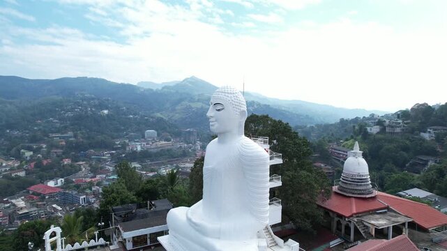 Aerial drone footage of the great Buddha Sri Maha Bodhi Viharaya in the city of Kandy, Sri Lanka, on a sunny day, 4k 30fps, 1 inch sensor