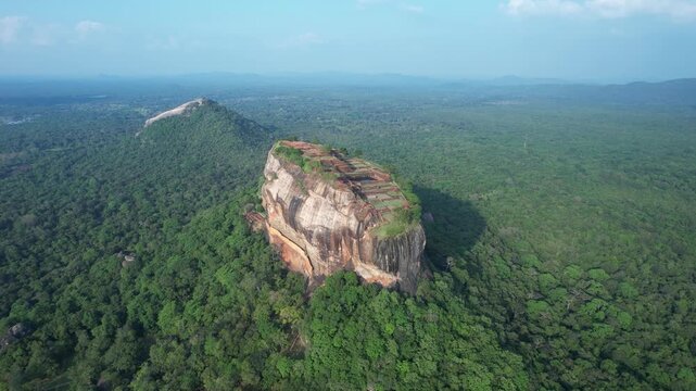 Aerial drone footage of Lion Rock in the city of Sigiriya in Sri Lanka on a sunny day, 4k 30fps, 1 inch sensor