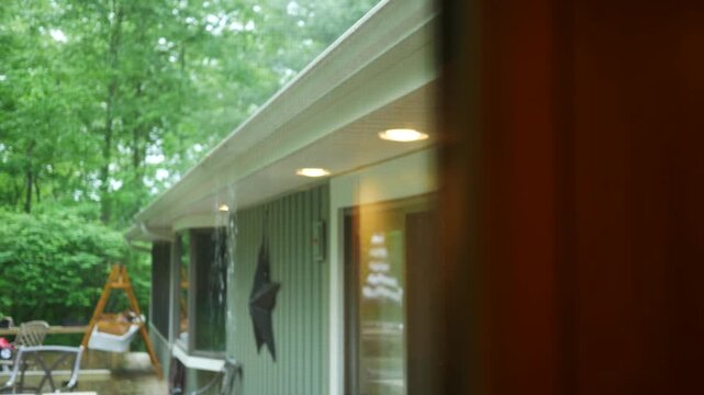 Rain Falling over Full Gutter in Ranch Style House